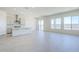 Bright open-plan living area showcasing hardwood floors, a modern kitchen, a dining area, and plenty of natural light at 20263 W Catalina Dr, Buckeye, AZ 85396