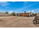 Large backyard with a mix of dirt and concrete, with block wall and mature trees at 299 N Comanche Dr, Chandler, AZ 85224