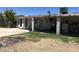 View of the backyard and patio area with brick supports and covered structure offering shade at 299 N Comanche Dr, Chandler, AZ 85224