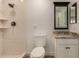Bright bathroom featuring a tiled shower, modern vanity with granite countertop, and neutral color palette at 299 N Comanche Dr, Chandler, AZ 85224