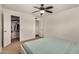 Bedroom with carpet, a ceiling fan, and a walk-in closet for ample storage at 299 N Comanche Dr, Chandler, AZ 85224