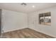 Cozy dining area features wood-look flooring, a window, and a nearby door at 299 N Comanche Dr, Chandler, AZ 85224