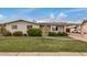 Charming single-story brick home featuring a covered carport and well-manicured front yard with mature landscaping at 299 N Comanche Dr, Chandler, AZ 85224