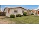 Charming single-story home with fresh landscaping, green grass, and a white brick exterior at 299 N Comanche Dr, Chandler, AZ 85224