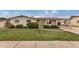Charming single-story home featuring a well-manicured lawn, fresh landscaping, and a covered carport at 299 N Comanche Dr, Chandler, AZ 85224