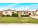 Charming single-story home featuring a well-manicured lawn and a covered carport at 299 N Comanche Dr, Chandler, AZ 85224