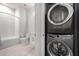 Efficient bathroom with stacked washer and dryer plus tub with white tile at 3131 N Central Ave # 7002, Phoenix, AZ 85012