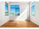Sunlit bedroom with hardwood floors and large windows offering a pleasant neighborhood view at 3131 N Central Ave # 7002, Phoenix, AZ 85012
