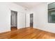 Bright bedroom with hardwood floors, white walls and multiple access points at 3131 N Central Ave # 7002, Phoenix, AZ 85012