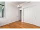 Bright bedroom with hardwood floors, white walls, and sliding-door closet at 3131 N Central Ave # 7002, Phoenix, AZ 85012
