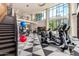 Well-equipped gym with modern fitness equipment and large windows, providing a bright workout space at 3131 N Central Ave # 7002, Phoenix, AZ 85012