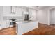 Bright kitchen features an island with stone countertops, stainless steel appliances, and hardwood floors at 3131 N Central Ave # 7002, Phoenix, AZ 85012