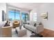 Comfortable living room with bright windows and a sliding glass door to balcony with nice city views at 3131 N Central Ave # 7002, Phoenix, AZ 85012
