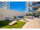 Relaxing patio with outdoor seating, a modern design, and a cornhole game for entertainment at 3131 N Central Ave # 7002, Phoenix, AZ 85012