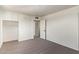 Bright bedroom featuring gray wood-look floors, white walls and an open door at 3222 W Marshall Ave, Phoenix, AZ 85017