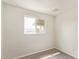 Bright bedroom with fresh white paint and gray hardwood flooring, complemented by a window with natural light at 3222 W Marshall Ave, Phoenix, AZ 85017
