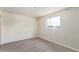 Bright room features gray wood-look floors and a window for natural light at 3222 W Marshall Ave, Phoenix, AZ 85017
