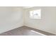 This is a bedroom showcasing fresh white walls, gray flooring, and a window providing natural light at 3222 W Marshall Ave, Phoenix, AZ 85017