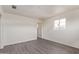 Spacious bedroom features gray wood-look floors, white walls, and a large window at 3222 W Marshall Ave, Phoenix, AZ 85017