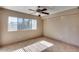 Spacious bedroom with tile flooring, a ceiling fan, and a large window at 3339 W Mohawk Ln, Phoenix, AZ 85027