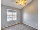Bedroom featuring carpet floors, ceiling fan and large window with exterior views at 3339 W Mohawk Ln, Phoenix, AZ 85027