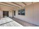 Covered patio featuring tile flooring, sliding glass doors, and windows with views of the backyard at 3339 W Mohawk Ln, Phoenix, AZ 85027