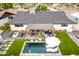 Aerial perspective showcasing the backyard's impressive pool, pergola-covered dining, and modern outdoor living spaces at 3619 N 87Th St, Scottsdale, AZ 85251