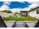 Beautiful backyard with a pergola covered seating area, lawn, and lounge chairs at 3619 N 87Th St, Scottsdale, AZ 85251