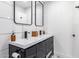 Modern bathroom featuring double vanity, sleek black fixtures, and stylish tilework, offering a contemporary design at 3619 N 87Th St, Scottsdale, AZ 85251