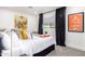Bright bedroom featuring a cozy bed with stylish decor, a window with black curtains, and modern accents at 3619 N 87Th St, Scottsdale, AZ 85251