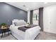 Cozy bedroom with a stylish gray accent wall, comfortable bed, and modern decor, creating a peaceful retreat at 3619 N 87Th St, Scottsdale, AZ 85251