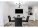 Dining area features modern chandelier, small table, and mounted television for contemporary living and entertainment at 3619 N 87Th St, Scottsdale, AZ 85251