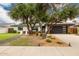 Attractive home with a modern garage door, mature trees, and meticulously maintained landscaping enhancing curb appeal at 3619 N 87Th St, Scottsdale, AZ 85251