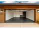Spacious garage features a dark-stained floor, storage cabinets, and ample room for vehicles at 3619 N 87Th St, Scottsdale, AZ 85251