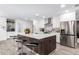 Modern kitchen features a large island with seating, white cabinets, and stainless steel appliances at 3619 N 87Th St, Scottsdale, AZ 85251