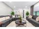 Comfortable living room featuring stylish gray sofas, decorative pillows, and a modern coffee table at 3619 N 87Th St, Scottsdale, AZ 85251