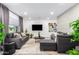 Modern living room featuring a gray sofa, contemporary decor, and plenty of natural light at 3619 N 87Th St, Scottsdale, AZ 85251
