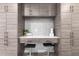 Chic home office features integrated cabinets, a seating area, and modern design at 3619 N 87Th St, Scottsdale, AZ 85251