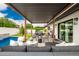 Stylish backyard features a pergola-covered lounge area, ample seating, and a refreshing pool at 3619 N 87Th St, Scottsdale, AZ 85251