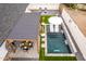 Aerial view of an outdoor pool with a pergola-covered dining area, lounge chairs, and decorative plants at 3619 N 87Th St, Scottsdale, AZ 85251