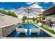 Relaxing pool area with in-pool loungers, a waterfall feature, and a seating area at 3619 N 87Th St, Scottsdale, AZ 85251