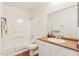 Bathroom with a shower-tub combo, tile floors, white cabinets, and a mirror at 3830 E Lakewood Pkwy # 2162, Phoenix, AZ 85048