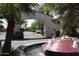 Community entrance with an arched gateway and a fountain surrounded by lush greenery and palm trees at 3830 E Lakewood Pkwy # 2162, Phoenix, AZ 85048
