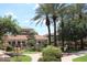 Luxurious villas with red tile roofs are surrounded by lush landscaping and walkways on a sunny day at 3830 E Lakewood Pkwy # 2162, Phoenix, AZ 85048