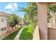 Relaxing patio area with views of green space, trees, and condo building at 3830 E Lakewood Pkwy # 2162, Phoenix, AZ 85048