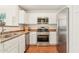 Modern kitchen with stainless steel appliances, white cabinets, and ample counter space at 3830 E Lakewood Pkwy # 2162, Phoenix, AZ 85048