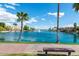Serene lake view with lush greenery, palm trees, and waterfront homes under a clear blue sky at 3830 E Lakewood Pkwy # 2162, Phoenix, AZ 85048