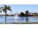 Scenic lake view showcasing a water fountain and waterfront homes, with a mountain range in the distance at 3830 E Lakewood Pkwy # 2162, Phoenix, AZ 85048