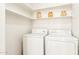 Convenient laundry room with washer, dryer, and overhead shelving for storage and organization at 3830 E Lakewood Pkwy # 2162, Phoenix, AZ 85048