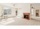 Bright living room featuring large windows, a ceiling fan, and a cozy fireplace at 3830 E Lakewood Pkwy # 2162, Phoenix, AZ 85048